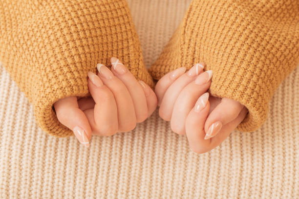 istock womans hands with manicure with  knitted blanket 1633816986