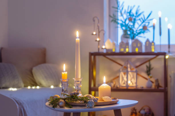 istock beautiful white room with christmas decor with burning candles 1633816994