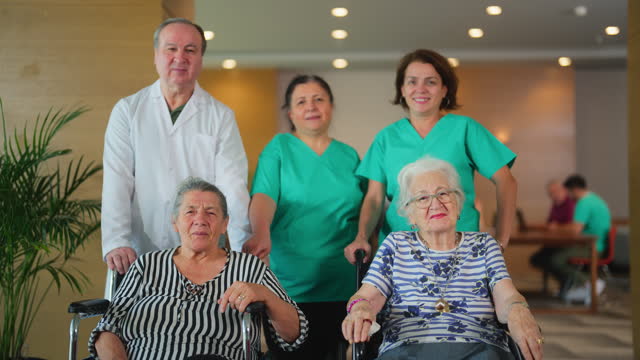 Group portrait of group of medical care giver workers and two senior women
