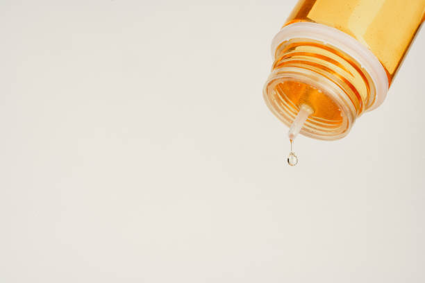 istock Vape liquid dripping from the bottle against white background 1633835588