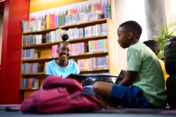istock Group of young children reading together 1633849115