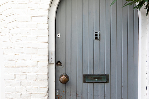 Closed grey door to a house in the city of Amsterdam