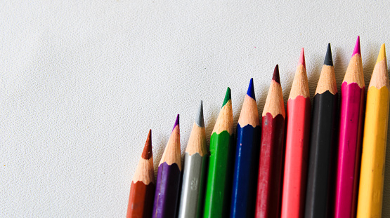 colorful colored pencils on a white background. copy space