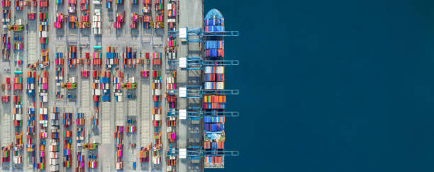 istock Industrial import-export port prepare to load containers. Aerial top view container ship in export and import global business and logistic. Global transportation and logistic business. 1633906141