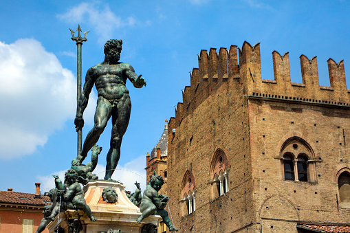 Fontana del Nettuno in front of Palazzo Re Enzo in old town Bologna, Italy.