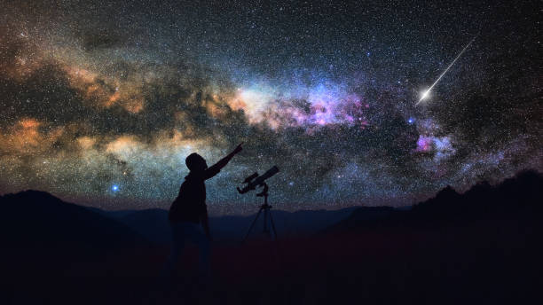 istock Astronomer looking at the starry skies with a telescope. 1633931299