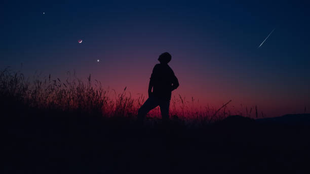 istock Man looking at planet conjunction and waxing Moon. 1633934508