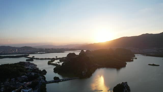 Aerial zoom out view of Seven Star Cave in China at sunset