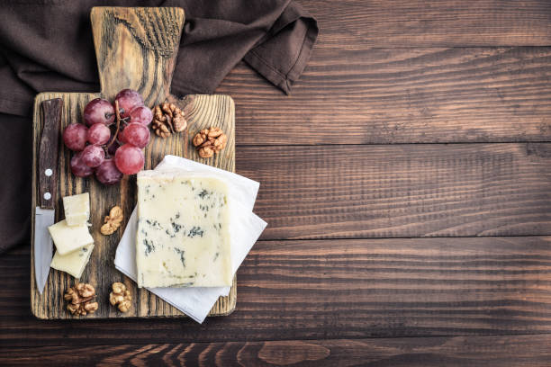 istock Slice of Gorgonzola cheese on cutting board 1633956240