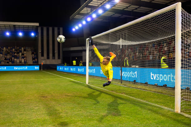 istock Football player diving mid-air 1633956980