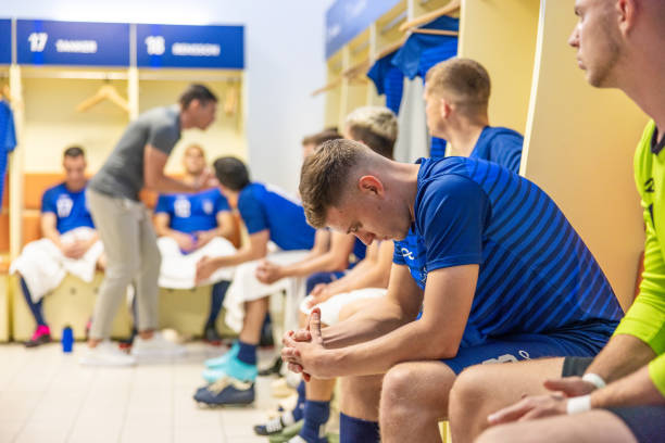 istock Thoughtful football player in dressing room 1633956986