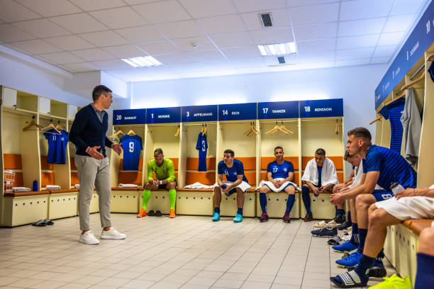istock Coach instructing football players 1633957008