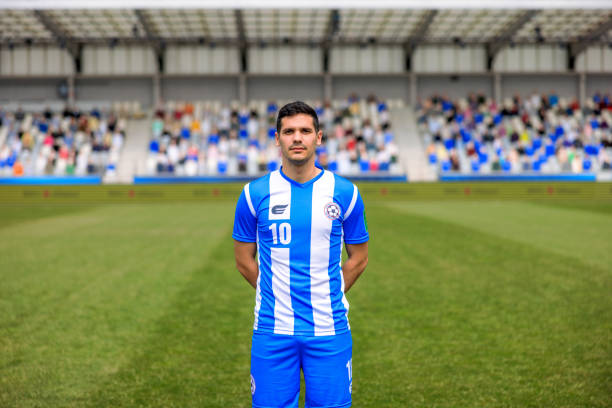istock Young man standing on football pitch 1633957061