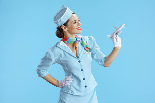 istock happy modern female air hostess on blue 1633957069