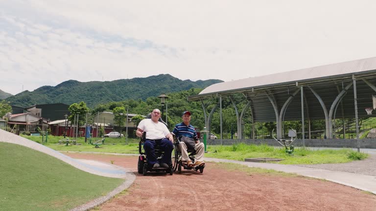 Two friends in wheelchairs taking a stroll in the park
