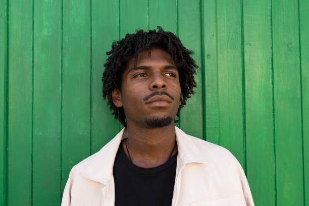 istock Young afro boy with curly hair thinking about something 1633957689