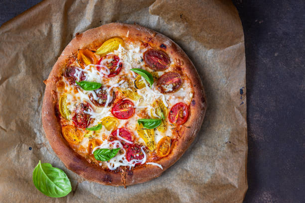 istock Fresh pizza with colorful tomatoes, mozzarella and basil. 1633957793