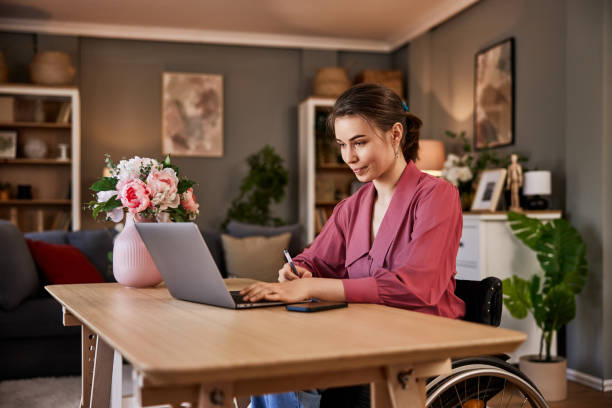 istock A focused female freelancer working on a laptop and writing notes in a notebook. 1633957880