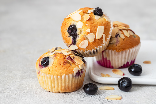 Fresh delicious muffins with blueberry and almonds