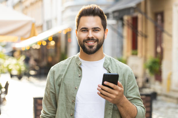 istock Young adult man use smartphone typing text messages browsing internet finishing work chatting online 1633993609