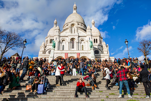 Paris, France - Feb. 07, 2016: Unidentified tourists visiting Sacre Coeur Cathedral on Montmartre. Sacre Coeur Cathedral is a Roman Catholic church,