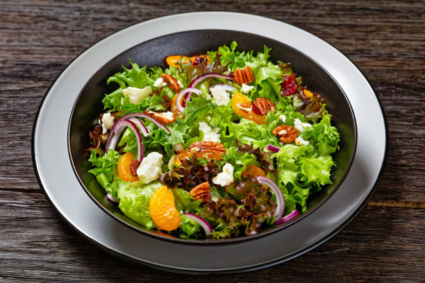 istock Mandarin Orange Salad in black bowl, top view 1633999509