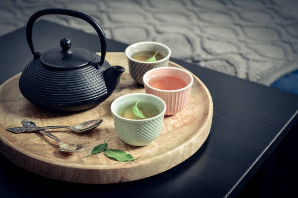 istock Black iron asian tea set on wooden tray 1634000574