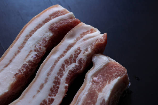 Raw pork belly in plastic container stock photo