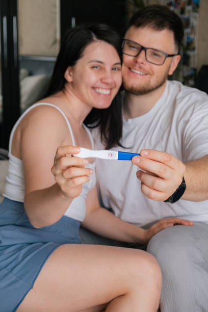 istock happy couple looking at positive pregnancy test 1634006556