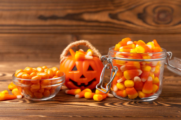 istock Halloween candy corn,jelly eye, pumpkin candy, sugar skull in different bowls on background.Classic candy sweets for Halloween with.Halloween holiday concept with candy corn and jack o lantern. 1634007150