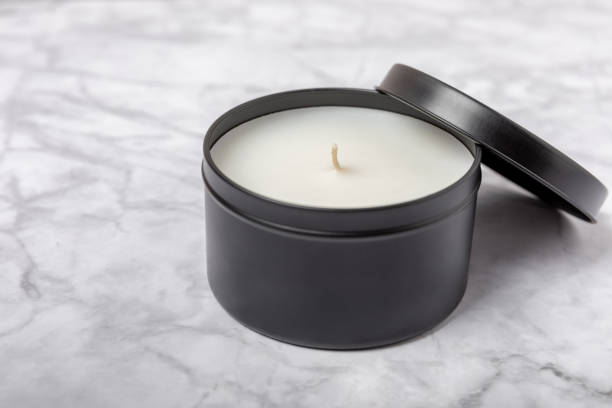 istock Soy candle in a black candlestick on a background. Space for text. Decor. 1634008229