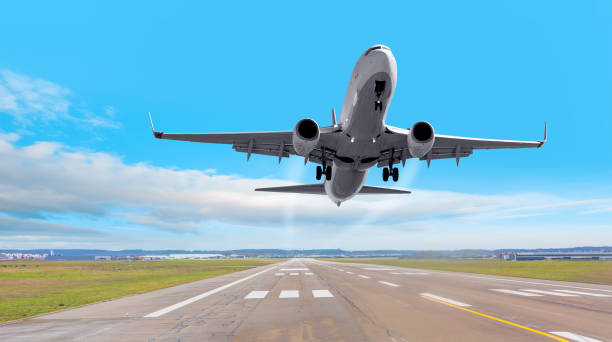 istock White Passenger plane fly up over take-off runway from airport 1634009325
