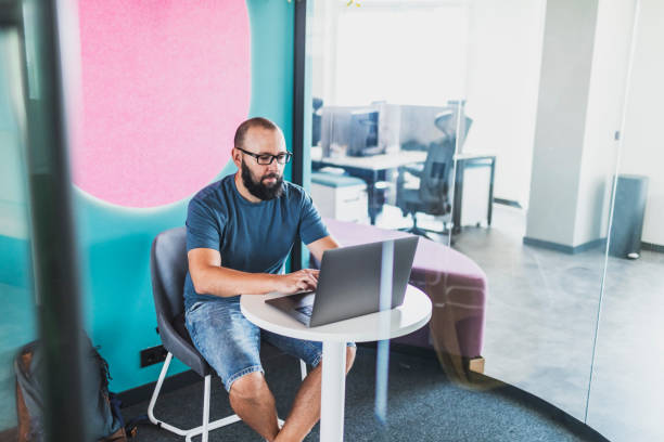istock Adult man coding on laptop at creative coworking office 1634012026