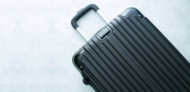 istock Black travel bag,Black luggage set on dark background, top view image, flat lay composition. Travel minimalist concept, black and dark classic baggage mockup, small and big. Suitcase accessor 1634015548