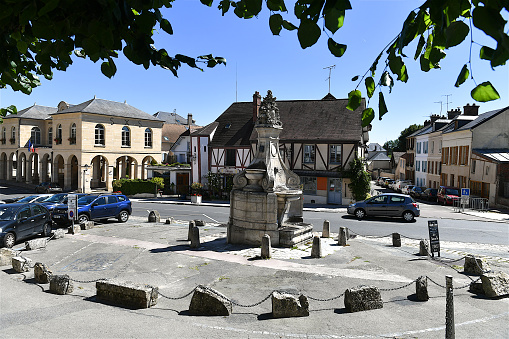 La Roche-Guyon, France-08 21 2023: Fountain in the center of the town square of La Roche-Guyon, France.