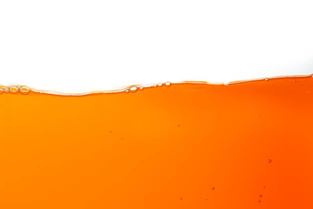 istock Macro orange juice texture isolated white background,Close-up Orange juice with bubbles on a white background. 1634020735