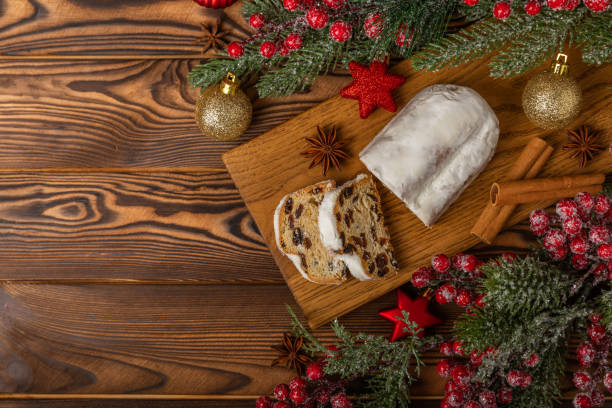 istock Christmas stollen on a texture table. Traditional German Christmas dessert cut into pieces. Cake with nuts, cinnamon, raisins, dried fruits and marzipan. baking for christmas. Place for text. 1634021863