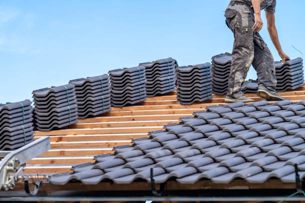 istock craftsman laying fired ceramic tiles on the roof 1634027878
