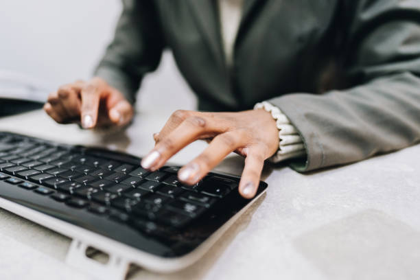 istock Close-up of female hands typing on a keyboard at work 1634052144