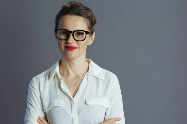 istock trendy female worker in white blouse against gray background 1634065015