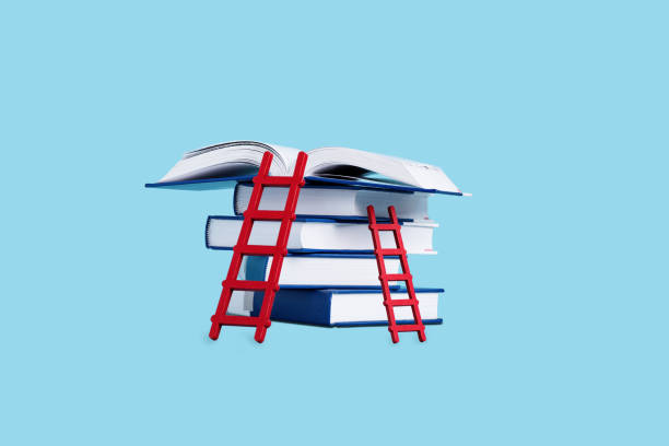 istock Creative collage with books and ladder on blue blackboard. 1634065548