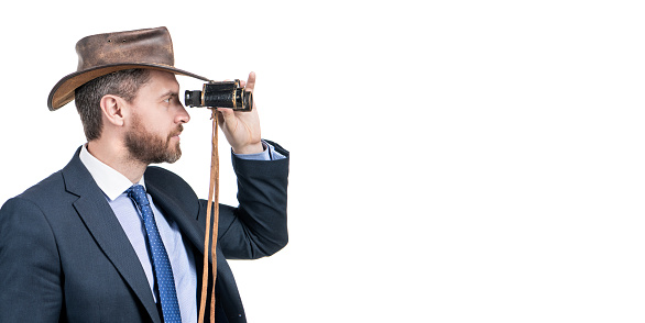 Professional man businessman in cowboy hat look through binoculars isolated on white copy space, business vision.