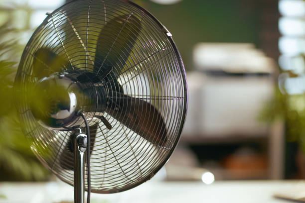 istock metal fan in modern green office 1634096438