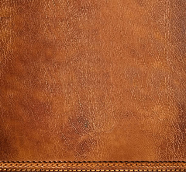 istock Horizontal or vertical leather background of brown colors with decorative braided edging. Decorative backdrop with cowhide texture and braided edge. Copy space for text 1634101877