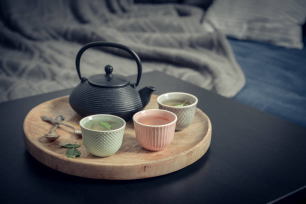 istock Black iron asian tea set on wooden tray 1634101883