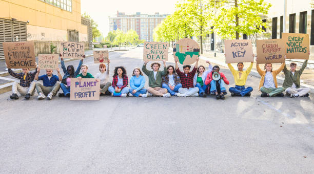 istock A group of young people protest by climate change and blocking the road 1634111588