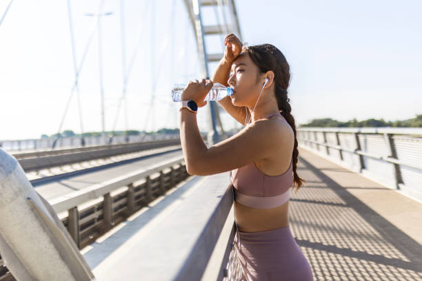 istock Asian Woman Rehydrates After a Vigorous Workout 1634116017