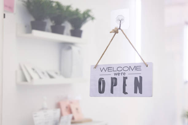 istock Open sign with welcome message in front of cafe store 1634136925