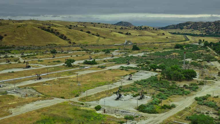 Rightward Drone Shot of Pumpjacks in a California Oil Field