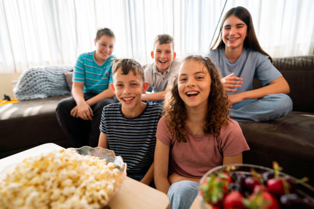 istock Group of children watching TV at home 1634181720